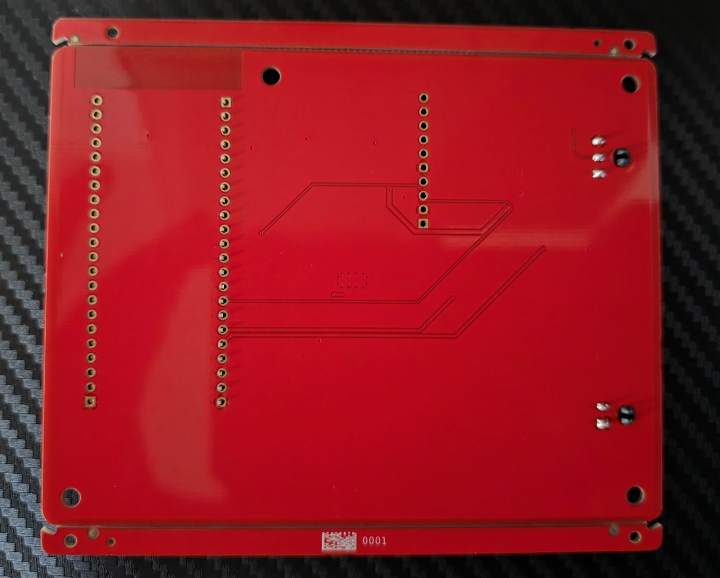 Photo of the bottom side of the prototype board showing the socket pins and routed traces.